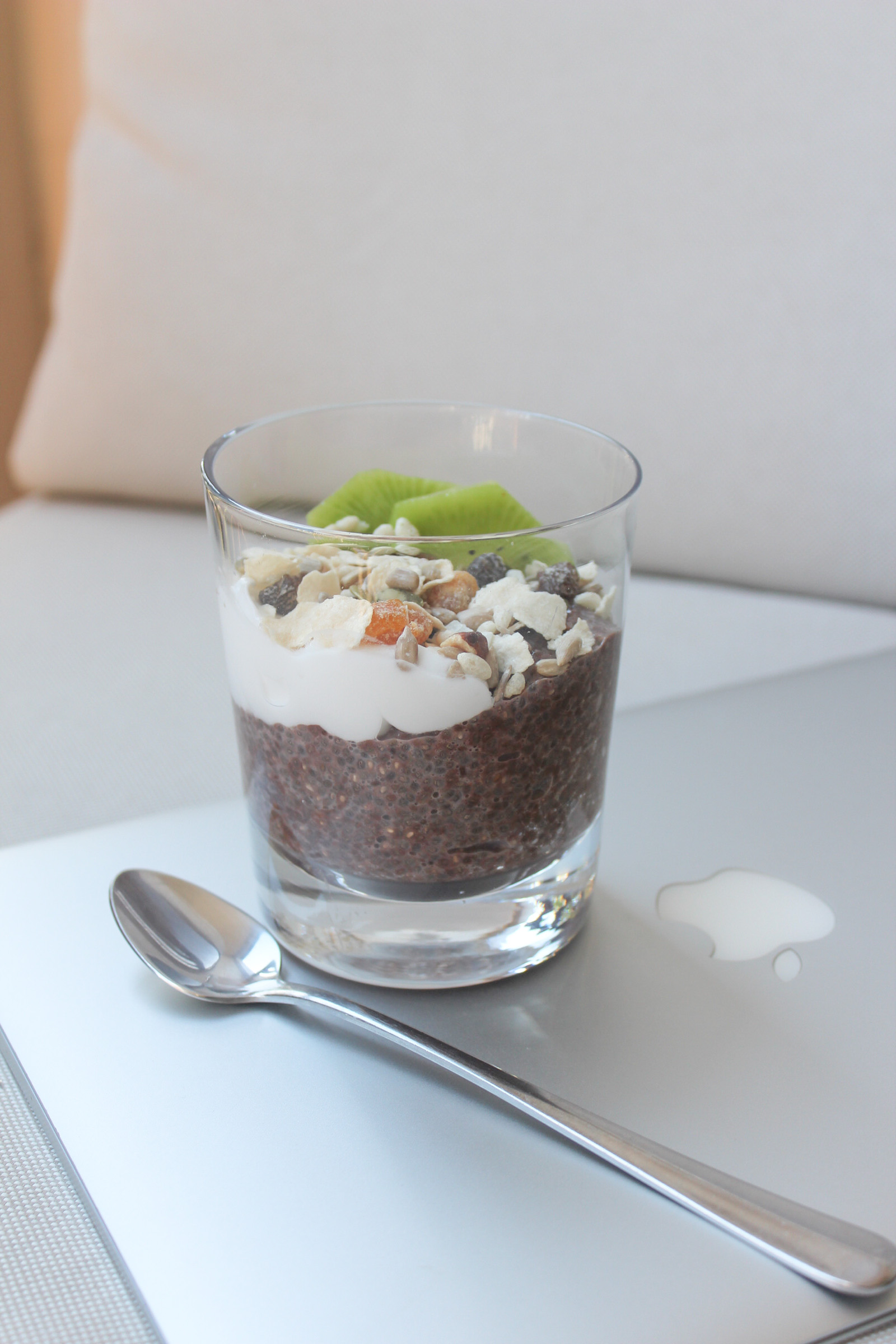 A photo of Chocolate Chia Seed Pudding topped with yoghurt, muesli and kiwi fruit