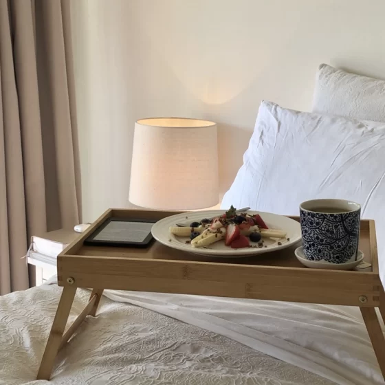Breakfast in bed, featuring a healthy banana split recipe, tea and a kindle.